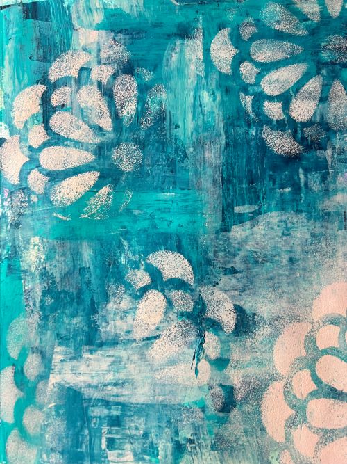 blue art journal page stenciled with acrylic paint